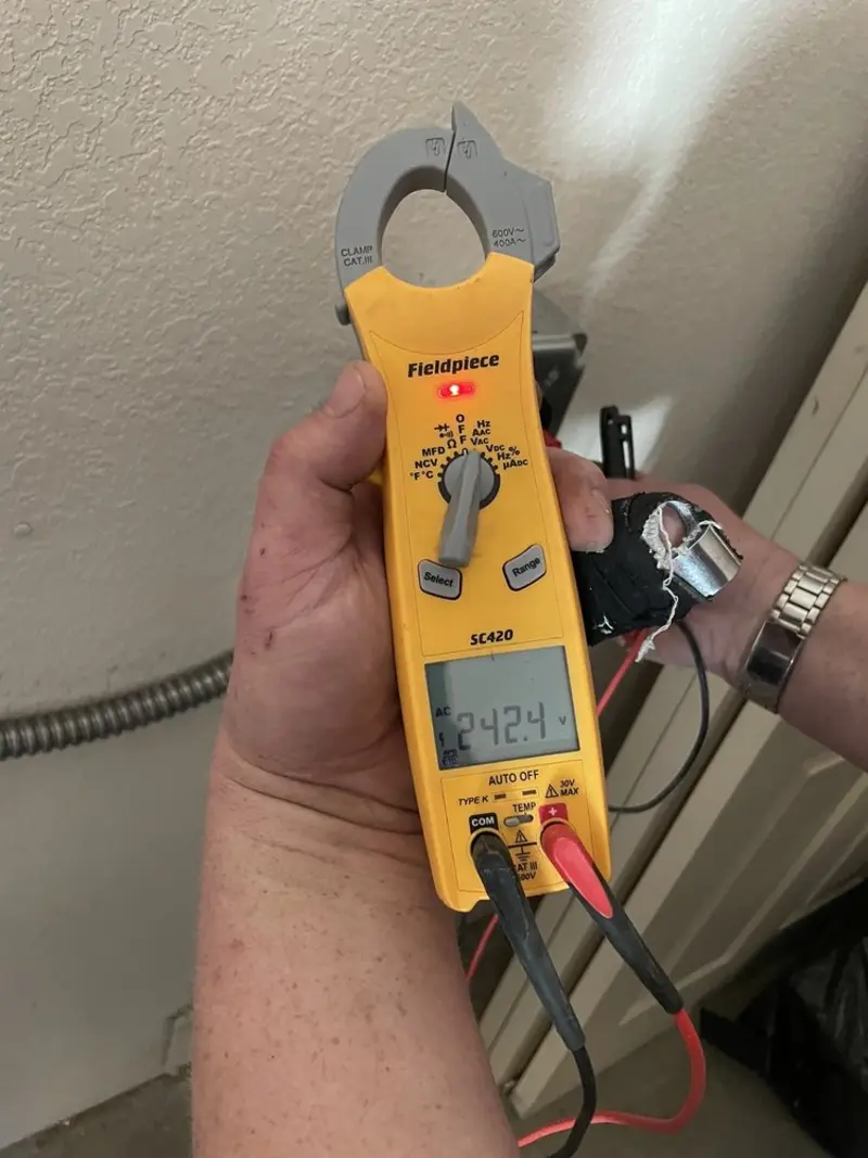 Voltage testing with clamp meter during Recessed Lighting Installation in Raymond